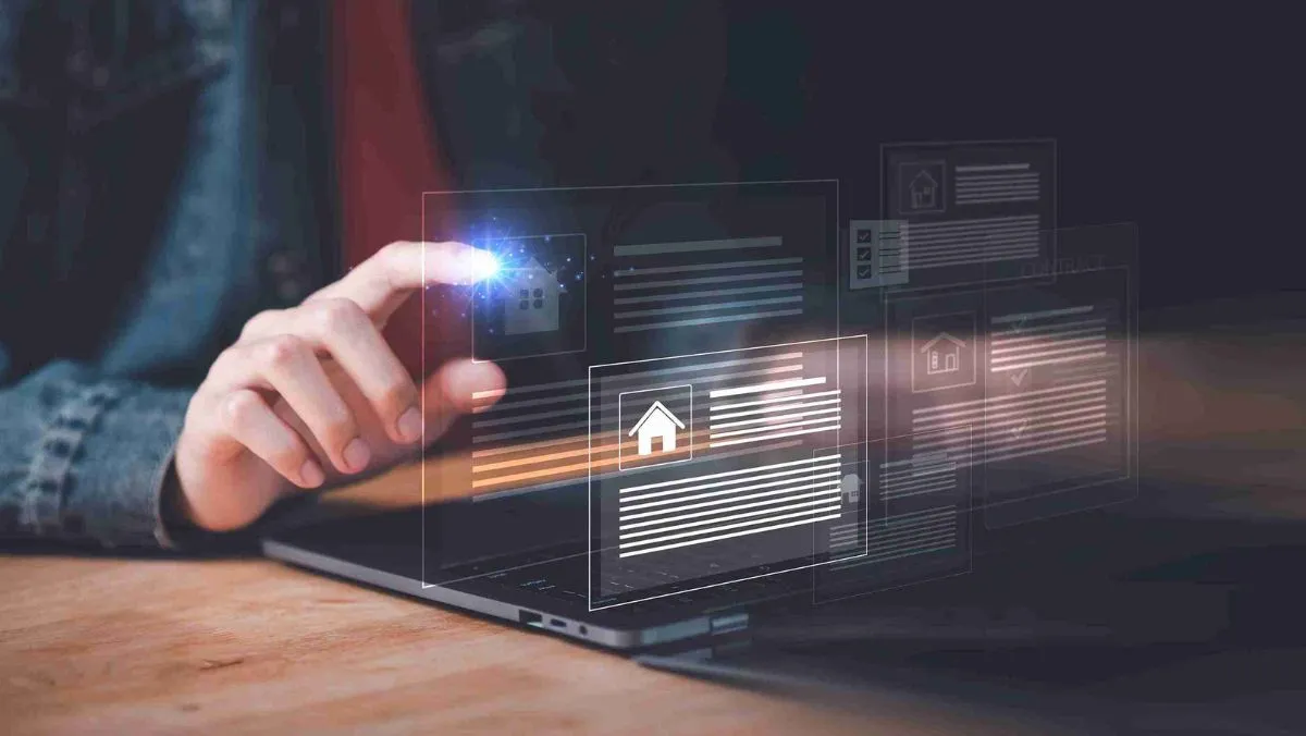 A person interacting with a hologram displaying a logo of a house and its details