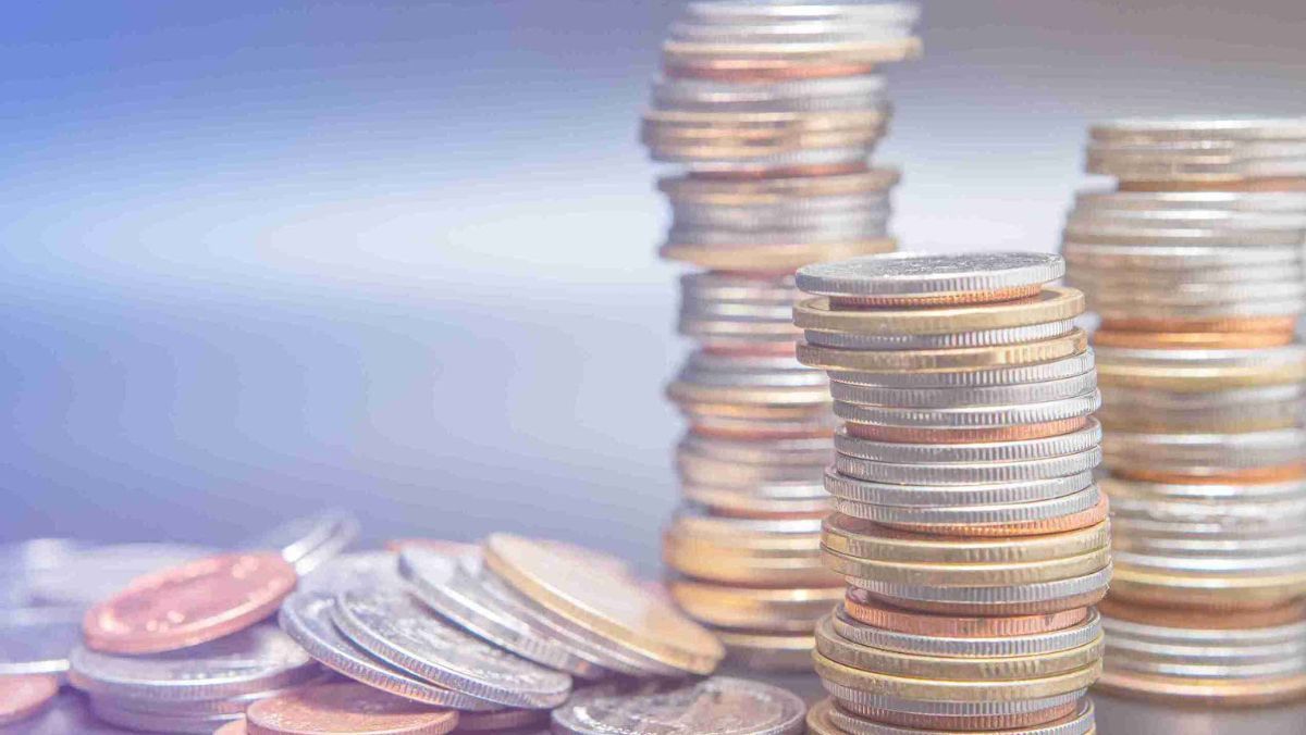 Assorted coins of varying denominations arranged in a stack on a flat surface