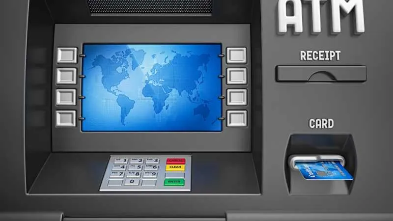 Close up of an ATM interface with a world map on the screen