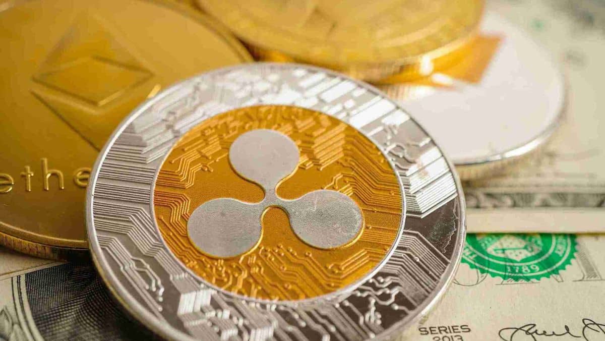 Close up view of a Ripple coin alongside other cryptocurrency coins