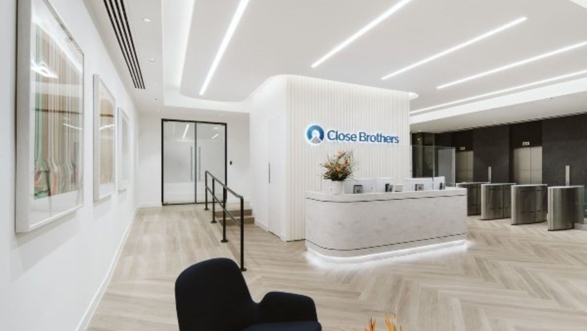 The reception area at Close Brothers is illuminated by vibrant-coloured lighting