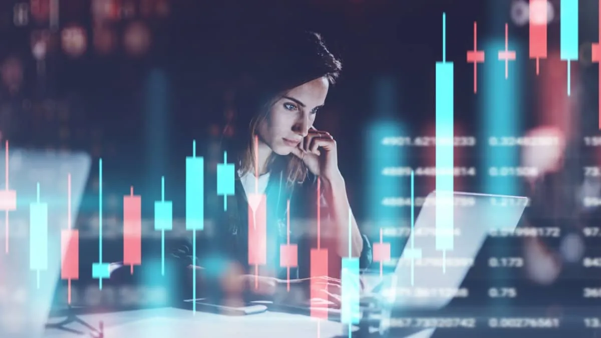 Young woman working at night modern office.Technical price graph and indicator, red and green candlestick chart and stock trading computer screen background. Double exposure.